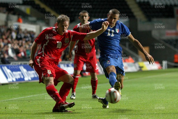 04.09.09 - Wales U21 v Italy U21, UEFA Under 21 Championship 2011 -  Wales' Simon Church crosses as Italy's Antonino Barilla  closes in  