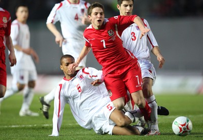 31.03.09 - Wales U21v Luxembourg U21, UEFA Under 21 Championship 2011, Llanelli -  Wales' Joe Allen  is brought down by Luxembourg's Gerard Seisbusch  for a penalty 