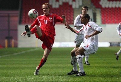 31.03.09 - Wales U21v Luxembourg U21, UEFA Under 21 Championship 2011, Llanelli -  Wales' Shaun MacDonald plays the ball over Luxembourg's Gerard Seisbusch    