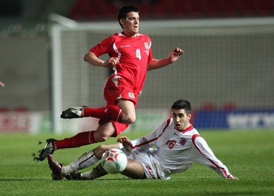 31.03.09 - Wales U21v Luxembourg U21, UEFA Under 21 Championship 2011, Llanelli -  Wales' Mark Bradley is tackled by Luxembourg's Geoffrey Croughs  
