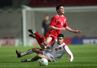 31.03.09 - Wales U21v Luxembourg U21, UEFA Under 21 Championship 2011, Llanelli -  Wales' Mark Bradley is tackled by Luxembourg's Geoffrey Croughs  