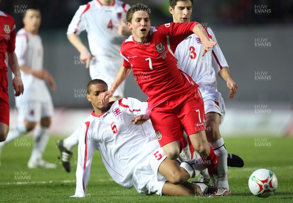 31.03.09 - Wales U21v Luxembourg U21, UEFA Under 21 Championship 2011, Llanelli -  Wales' Joe Allen  is brought down by Luxembourg's Gerard Seisbusch  for a penalty 