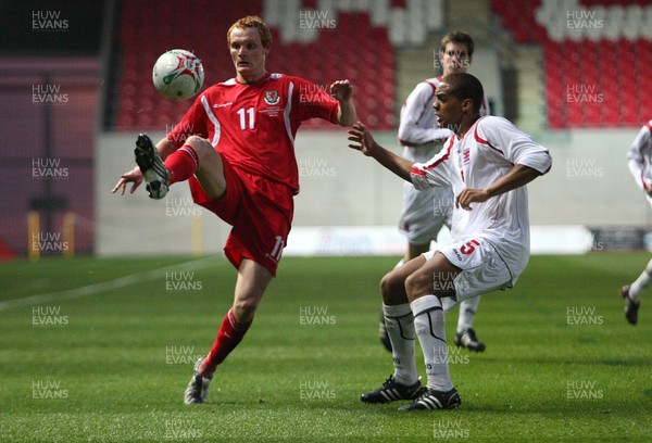 31.03.09 - Wales U21v Luxembourg U21, UEFA Under 21 Championship 2011, Llanelli -  Wales' Shaun MacDonald plays the ball over Luxembourg's Gerard Seisbusch    