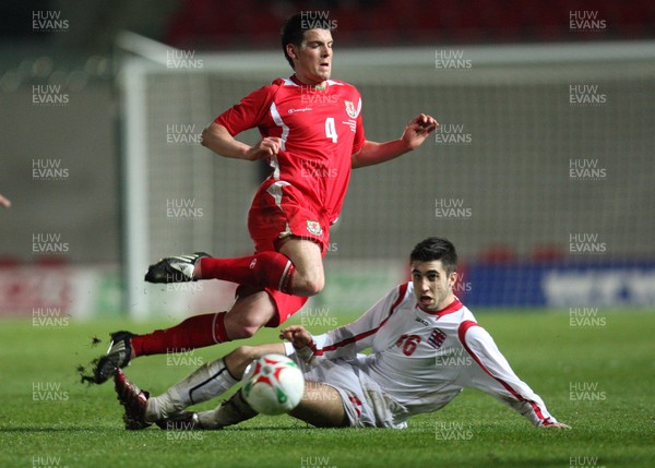 31.03.09 - Wales U21v Luxembourg U21, UEFA Under 21 Championship 2011, Llanelli -  Wales' Mark Bradley is tackled by Luxembourg's Geoffrey Croughs  