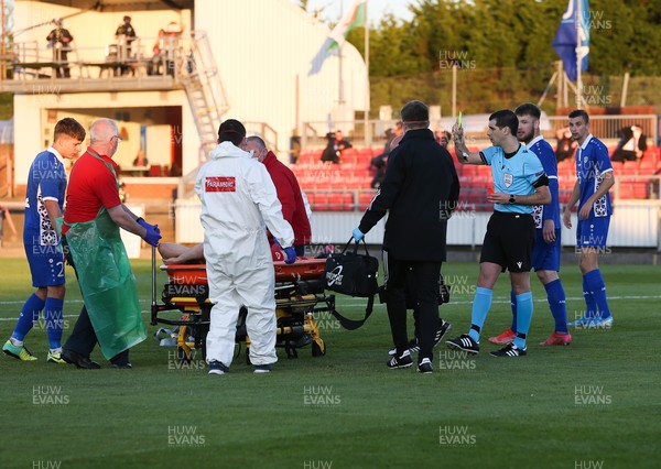 040621 - Wales U21 v Moldova U21, UEFA U21 EURO 2023 Qualifying Match - Referee Matthew De Gabriele shows a second yellow card, followed by a red card to Sion Spence of Wales as he is stretchered off the pitch