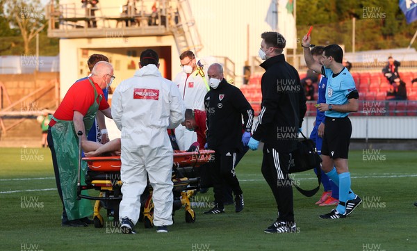 040621 - Wales U21 v Moldova U21, UEFA U21 EURO 2023 Qualifying Match - Referee Matthew De Gabriele shows a red card following a second yellow to Sion Spence of Wales as he is stretchered off the pitch