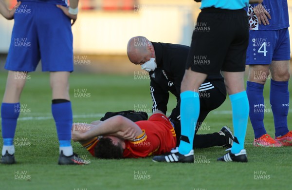 040621 - Wales U21 v Moldova U21, UEFA U21 EURO 2023 Qualifying Match - Sion Spence of Wales receives treatment before being stretchered off while being shown a red card