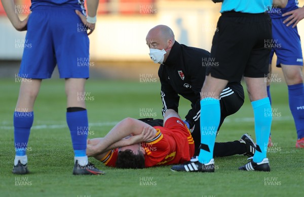 040621 - Wales U21 v Moldova U21, UEFA U21 EURO 2023 Qualifying Match - Sion Spence of Wales receives treatment before being stretchered off while being shown a red card