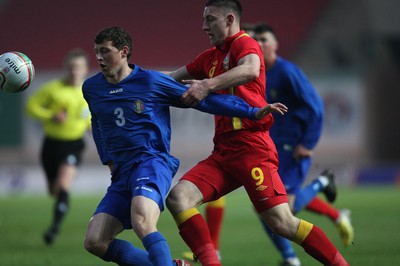 220313 - Wales U21 v Moldova U21 UEFA Championship Qualifying match, Llanelli - Wales' Jake Cassidy takes on Moldova's Maxim Focsa