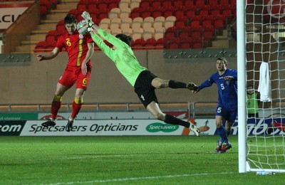 220313 - Wales U21 v Moldova U21 UEFA Championship Qualifying match, Llanelli - Wales' Joe Walsh and Moldova's keeper Alexi Koselev contest the ball