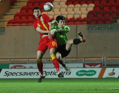 220313 - Wales U21 v Moldova U21 UEFA Championship Qualifying match, Llanelli - Wales' Joe Walsh and Moldova's keeper Alexi Koselev contest the ball