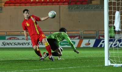 220313 - Wales U21 v Moldova U21 UEFA Championship Qualifying match, Llanelli - Wales' Joe Walsh and Moldova's keeper Alexi Koselev contest the ball