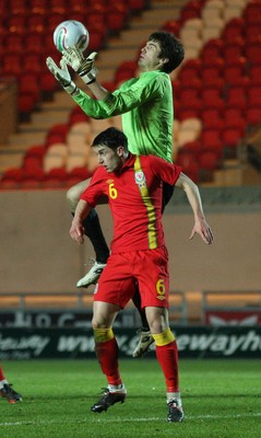 220313 - Wales U21 v Moldova U21 UEFA Championship Qualifying match, Llanelli - Moldova's keeper Alexi Koselev gets above Wales' Joe Walsh