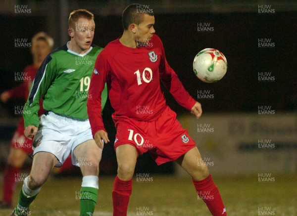 280206 - Wales U21 v Northern Ireland U21 - International Under 21 Challenge Match - Stebonheath Park, Llanelli - Wales' Ramon Calliste tries to control the ball as Kyle McVey closes in 