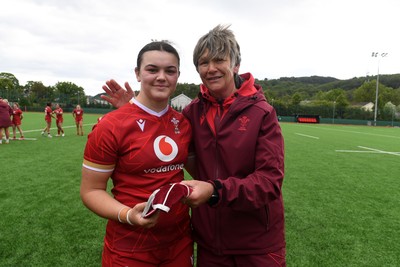 100526 - Wales U21 Women v Ireland U21 Women - Six Nations Women's U21 Series - Chiara Pearce of Wales Women is presented a cap by Liza Burgess, Wales Women's Head Coach