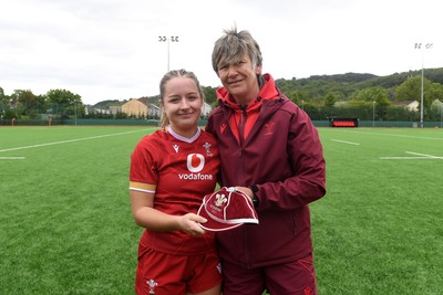 100526 - Wales U21 Women v Ireland U21 Women - Six Nations Women's U21 Series - Hanna Tudor of Wales Women is presented a cap by Liza Burgess, Wales Women's Head Coach
