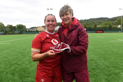 100526 - Wales U21 Women v Ireland U21 Women - Six Nations Women's U21 Series - Katherine Baverstock of Wales Women is presented a cap by Liza Burgess, Wales Women's Head Coach