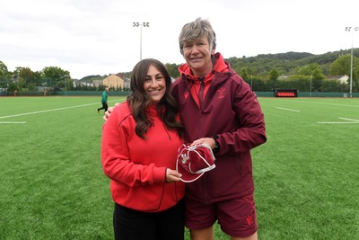 100526 - Wales U21 Women v Ireland U21 Women - Six Nations Women's U21 Series - Katie Bevans of Wales Women is presented a cap by Liza Burgess, Wales Women's Head Coach