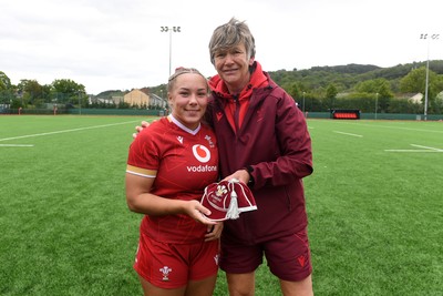 100526 - Wales U21 Women v Ireland U21 Women - Six Nations Women's U21 Series - Kelsie Webster of Wales Women is presented a cap by Liza Burgess, Wales Women's Head Coach