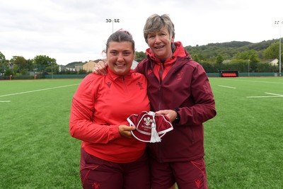100526 - Wales U21 Women v Ireland U21 Women - Six Nations Women's U21 Series - Stella Orrin of Wales Women is presented a cap by Liza Burgess, Wales Women's Head Coach
