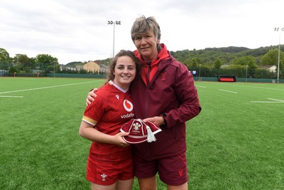 100526 - Wales U21 Women v Ireland U21 Women - Six Nations Women's U21 Series - Lily Hawkins of Wales Women is presented a cap by Liza Burgess, Wales Women's Head Coach