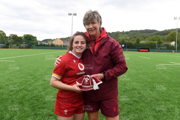 100526 - Wales U21 Women v Ireland U21 Women - Six Nations Women's U21 Series - Lily Hawkins of Wales Women is presented a cap by Liza Burgess, Wales Women's Head Coach