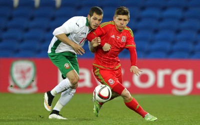 310315 -Wales U21s v Bulgaria U21s - UEFA U21 Championship Qualifier - Declan John of Wales tackles Georg Iliev of Bulgaria