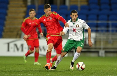 310315 -Wales U21s v Bulgaria U21s - UEFA U21 Championship Qualifier - Lee Evans of Wales tackles Georg Iliev of Bulgaria