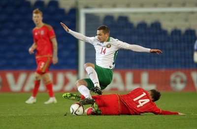 310315 -Wales U21s v Bulgaria U21s - UEFA U21 Championship Qualifier - Milcho Angelov of Bulgaria is tackled by Declan Weeks of Wales