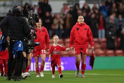 140426 - Wales v Albania - 2027 FIFA Women's World Cup Qualifying - Angharad James-Turner of Wales leads the team out with mascots prior to the game