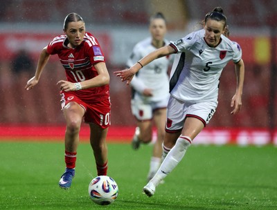 140426 - Wales v Albania - 2027 FIFA Women's World Cup Qualifying - Mared Griffiths of Wales runs with the ball whilst under pressure from Arbiona Bajraktari of Albania
