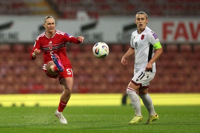 140426 - Wales v Albania - 2027 FIFA Women's World Cup Qualifying - Rhiannon Roberts of Wales passes the ball whilst under pressure from Megi Doci of Albania