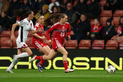 140426 - Wales v Albania - 2027 FIFA Women's World Cup Qualifying - Carrie Jones of Wales runs with the ball
