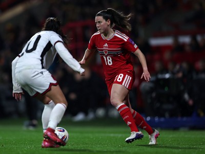 140426 - Wales v Albania - 2027 FIFA Women's World Cup Qualifying - Esther Morgan of Wales controls the ball whilst under pressure from Klea Hamonikaj of Albania