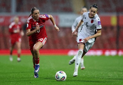 140426 - Wales v Albania - 2027 FIFA Women's World Cup Qualifying - Mared Griffiths of Wales runs with the ball whilst under pressure from Arbiona Bajraktari of Albania