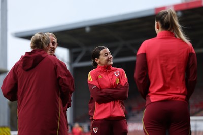 140426 - Wales v Albania - 2027 FIFA Women's World Cup Qualifying - Angharad James-Turner of Wales inspects the pitch with teammates prior to the match
