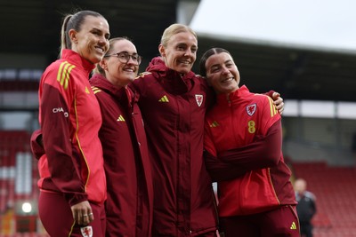 140426 - Wales v Albania - 2027 FIFA Women's World Cup Qualifying - Gemma Evans, Rachel Rowe, Sophie Ingle and Angharad James-turner of Wales pose for a photo on the pitch prior to the game