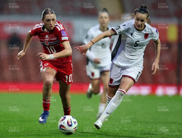 140426 - Wales v Albania - 2027 FIFA Women's World Cup Qualifying - Mared Griffiths of Wales runs with the ball whilst under pressure from Arbiona Bajraktari of Albania