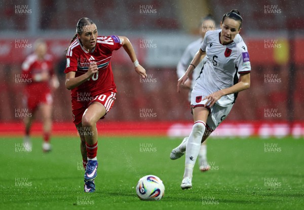 140426 - Wales v Albania - 2027 FIFA Women's World Cup Qualifying - Mared Griffiths of Wales runs with the ball whilst under pressure from Arbiona Bajraktari of Albania