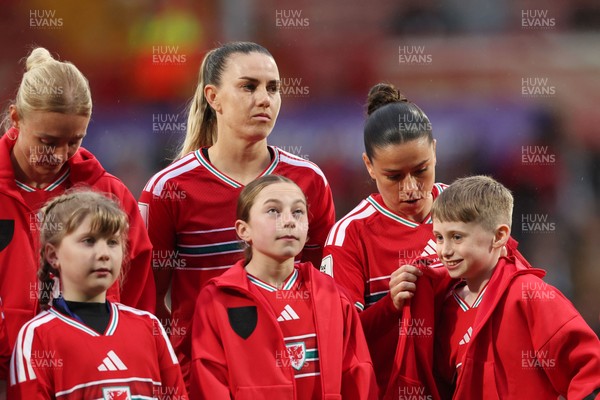 140426 - Wales v Albania - 2027 FIFA Women's World Cup Qualifying - Ffion Morgan of Wales gives her jacket to a mascot during the anthems