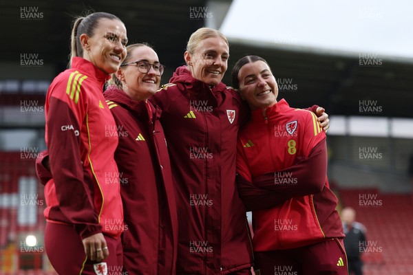 140426 - Wales v Albania - 2027 FIFA Women's World Cup Qualifying - Gemma Evans, Rachel Rowe, Sophie Ingle and Angharad James-turner of Wales pose for a photo on the pitch prior to the game