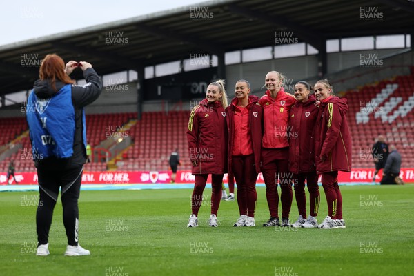 140426 - Wales v Albania - 2027 FIFA Women's World Cup Qualifying - Charlotte Estcourt, Soffia Kelly, Elise Hughes, Ffion Morgan of Wales pose for a photo on the pitch prior to the game 