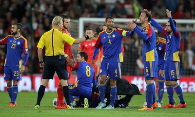 131015 - Wales v Andorra - UEFA European Championship Qualifiers - Andorra rush medics onto the pitch for Victor Moreira of Andorra