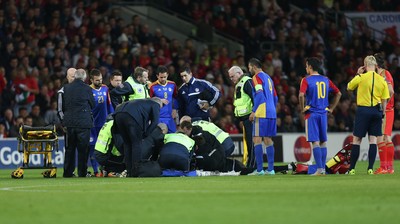 131015 - Wales v Andorra, UEFA European Championship Qualifier - Victor Moreira of Andorra receives extensive medical help after being injured, before being stretchered off