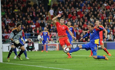 131015 - Wales v Andorra, UEFA European Championship Qualifier - Ildefonso Lima of Andorra beats Sam Vokes of Wales to the ball