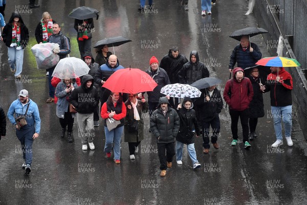 091125 - Wales v Argentina - Quilter Nations Series - Wales fans walk down Westgate Street in Cardiff in the rain ahead of the match