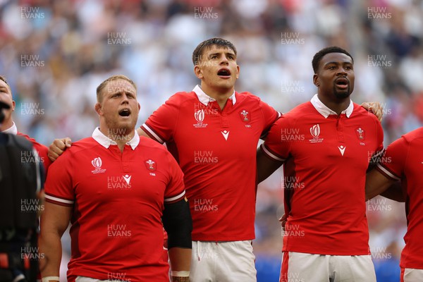 141023 - Wales v Argentina - Rugby World Cup Quarter Final - Corey Domachowski, Dafydd Jenkins and Christ Tshiunza of Wales sing the anthem