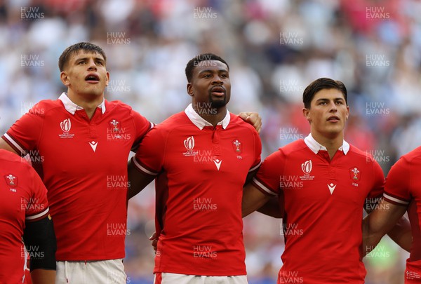 141023 - Wales v Argentina - Rugby World Cup Quarter Final - Dafydd Jenkins, Christ Tshiunza and Louis Rees-Zammit of Wales sing the anthem