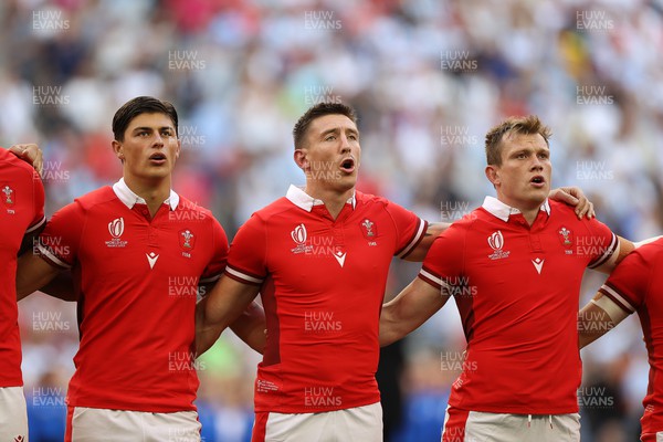 141023 - Wales v Argentina - Rugby World Cup Quarter Final - Louis Rees-Zammit, Josh Adams and Nick Tompkins of Wales sing the anthem