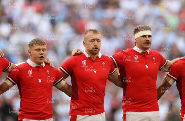 141023 - Wales v Argentina - Rugby World Cup Quarter Final - Sam Costelow, Tommy Reffell and Aaron Wainwright of Wales sing the anthem